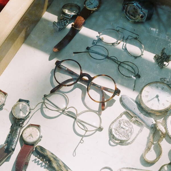 Vintage eyewear on display in a cabinet in Paris.