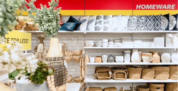 Display of homeware items including pillows, baskets, and decorative pieces.