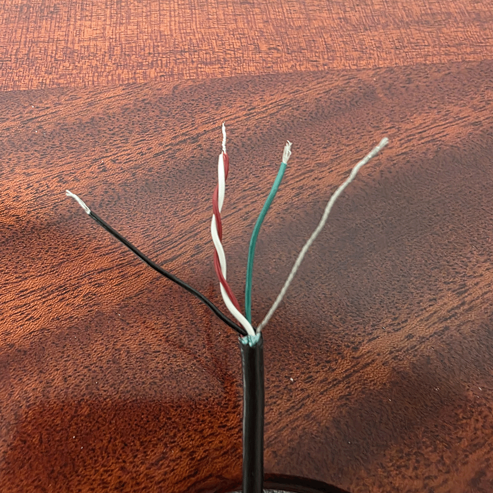 Wires stripped and separated, resting on a wooden surface.