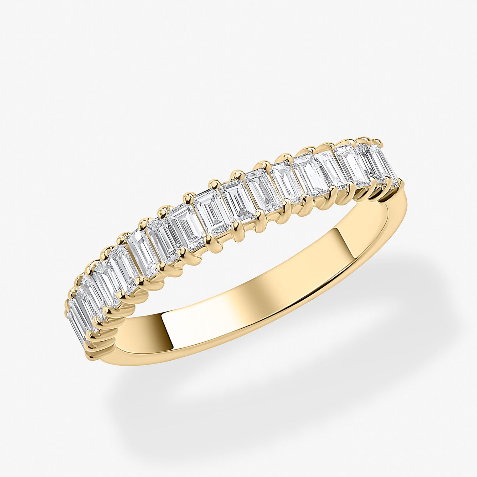 Yellow gold eternity band ring featuring a row of emerald-cut diamonds in a classic shared-prong setting.