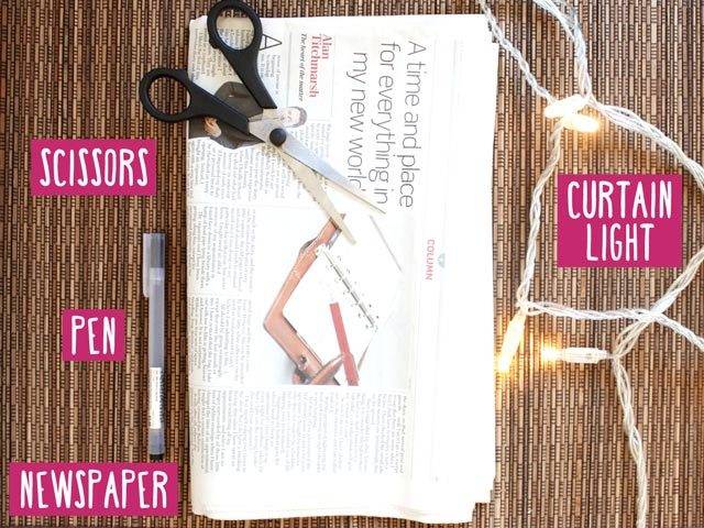Photo of scissors, pen, newspaper and curtain lights.