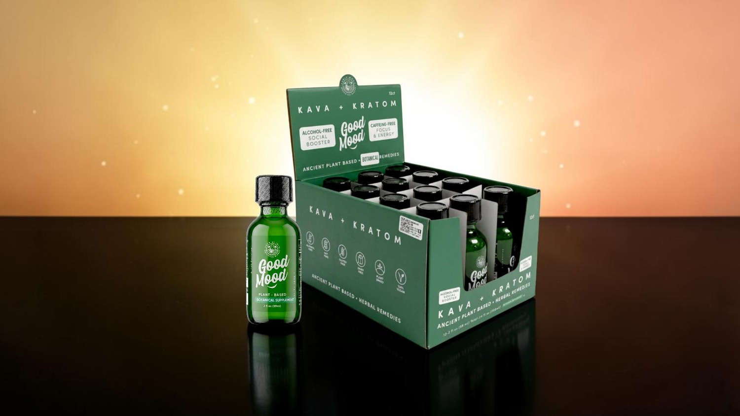 Green product box with individual bottles on a reflective surface.