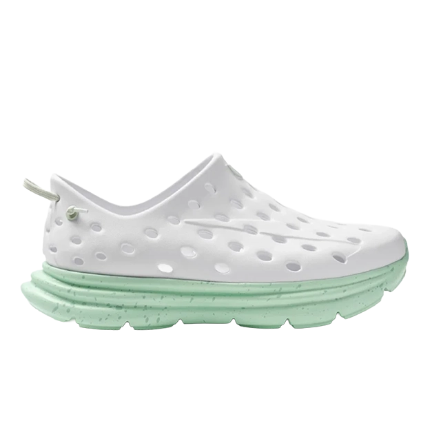 White perforated shoe with a mint green sole.