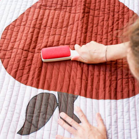 Removing Dust from a Quilt with a Lint Roller