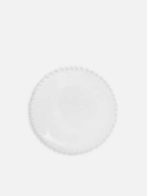 White decorative plate with a beaded edge.