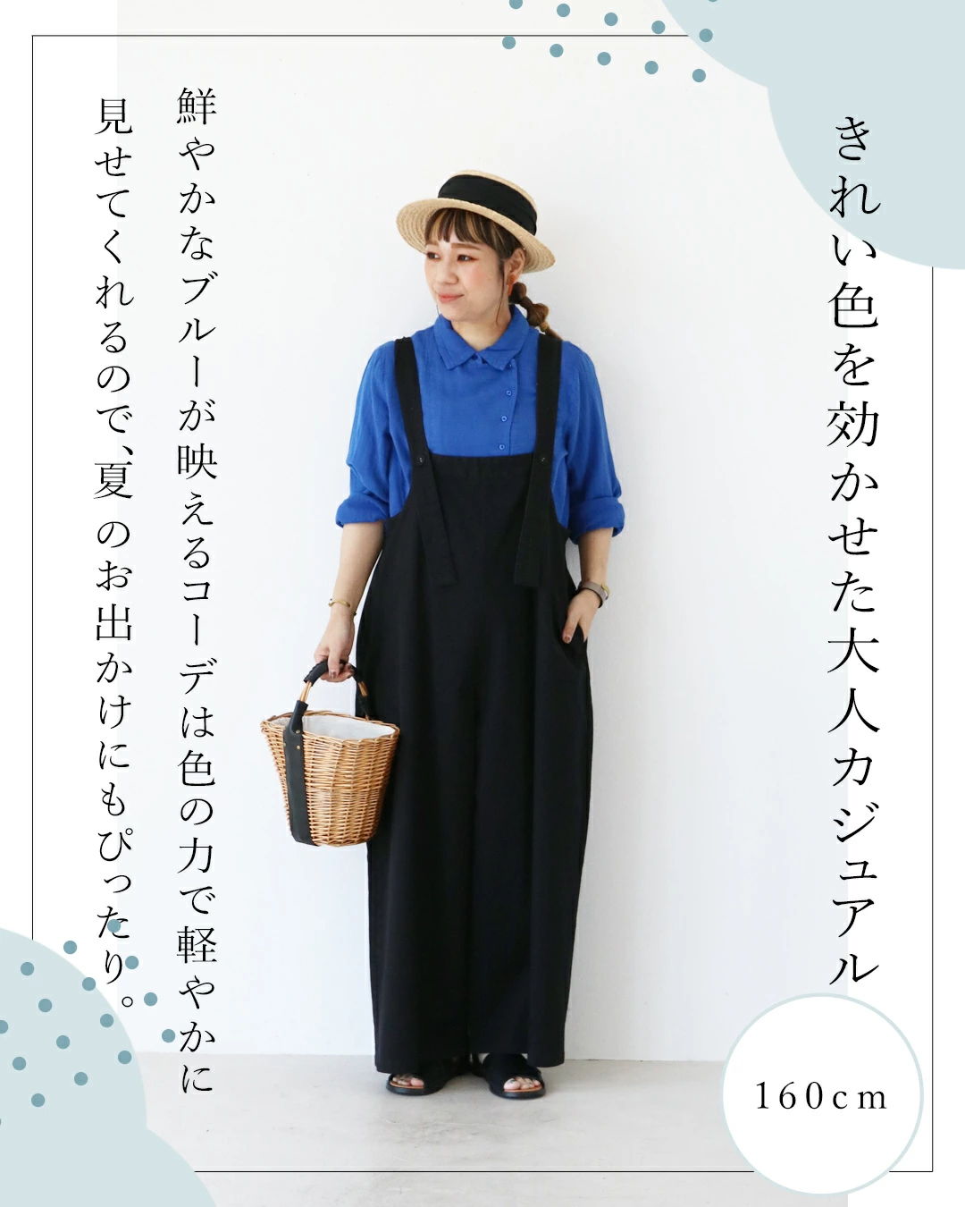 A person wearing a blue shirt and black overalls, holding a basket.