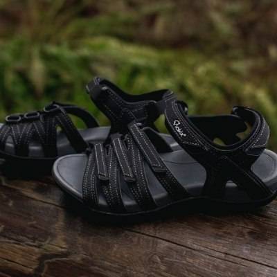 athletic sandals on a log