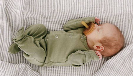 natural-dummy-newborn-baby-wearing-onsie-on-little-unicorn-cotton-swaddle-grey-stripe