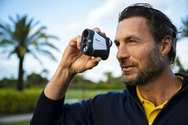 Golfer Looking Through the Nikon COOLSHOT 50i 2021 Golf Rangefinder with Slope