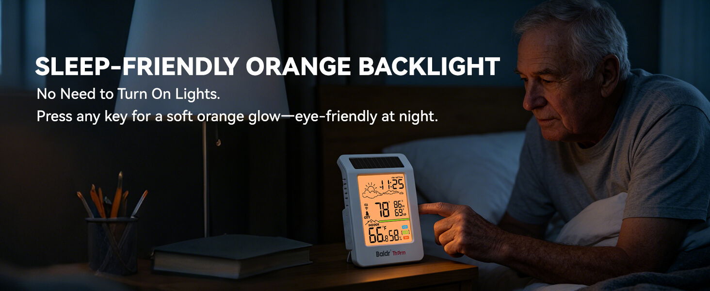 An older man using a device with an orange backlight at night.