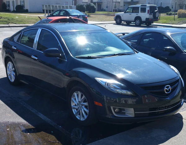 Front three-quarter dark 2012 Mazda 6 sedan chrome grille alloy wheels Michael's Conductor's Special 244K Spare Tire Delete train horn kit featured customer install gallery photo 1