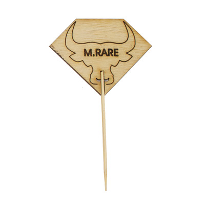 A skewer with a diamond shaped steak label reading 
