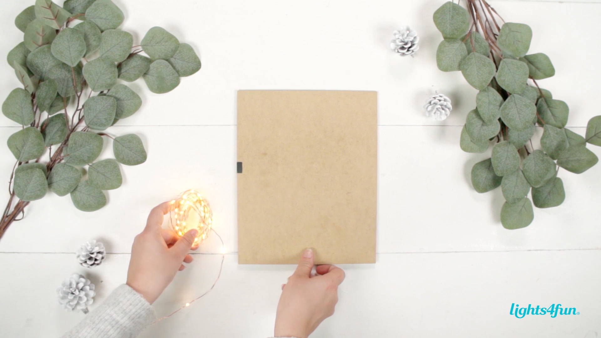 A DIY step of the Scandi Christmas decoration tutorial. Decorating the backboard with micro fairy lights.