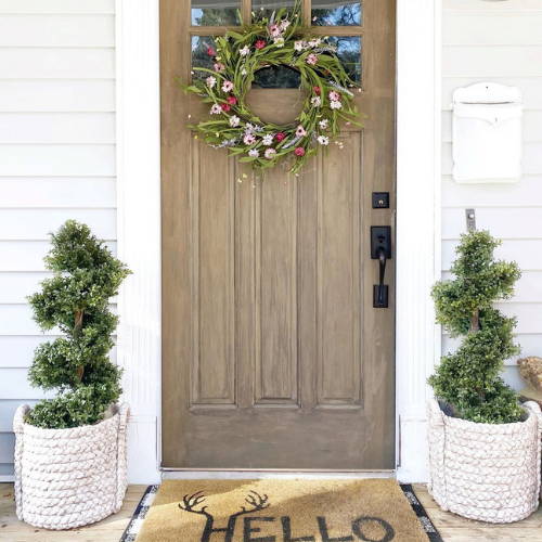 Nearly Natural topiary trees decorated at the entrance door