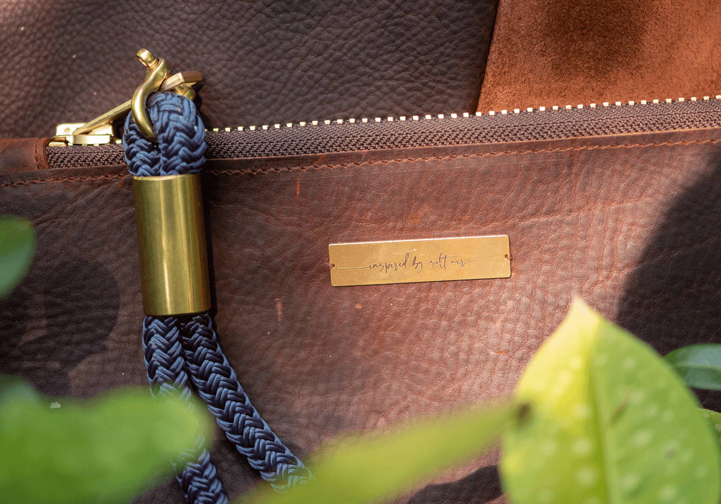 closeup on navy rope brown leather clutch