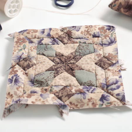an assembled quilt block on a table