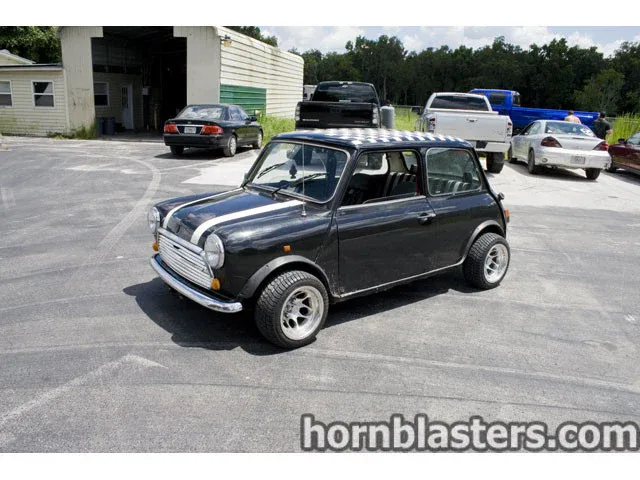 Angled front detail of Chad's 1970 MINI Cooper nose grille and lighting with Nightmare Edition install context photo 4
