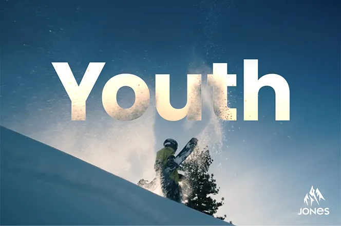 A snowboarder in action with the word 