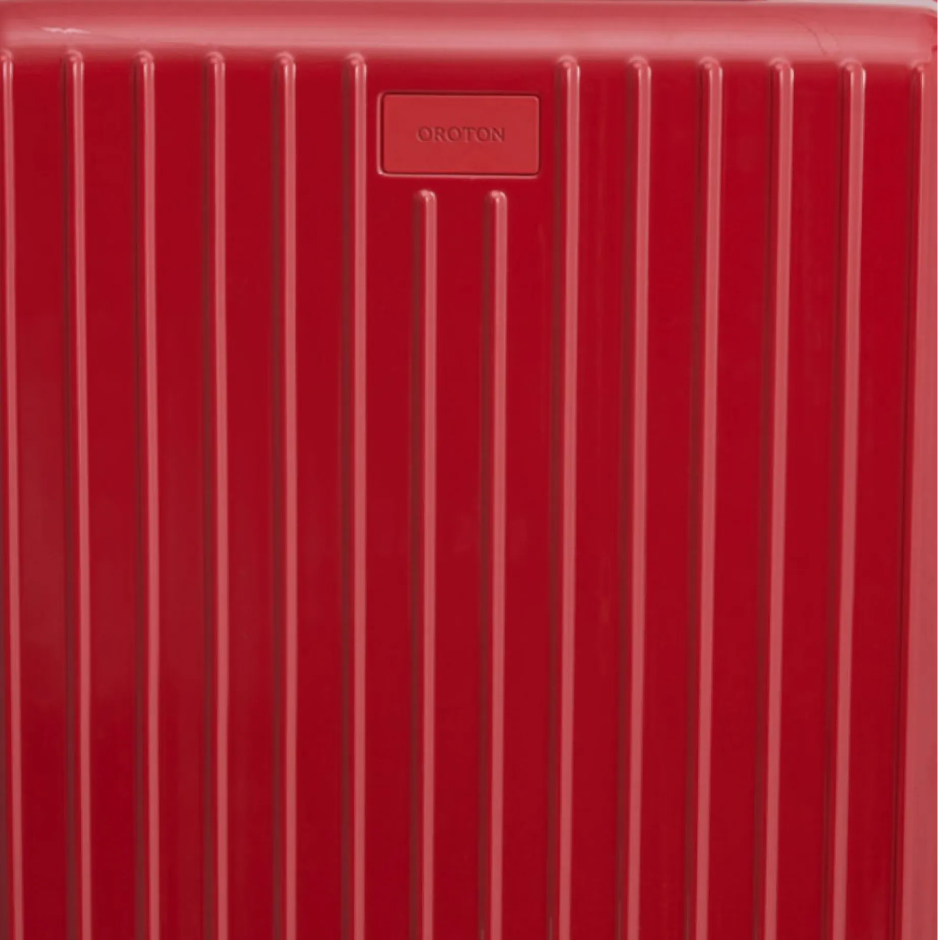 Red suitcase with vertical stripes and a logo plate.