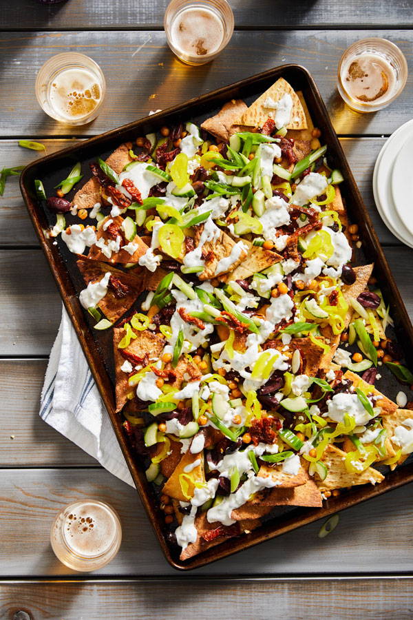 Mediterranean Nachos with briny olives, pickled peppers, sun-dried tomatoes and feta cheese