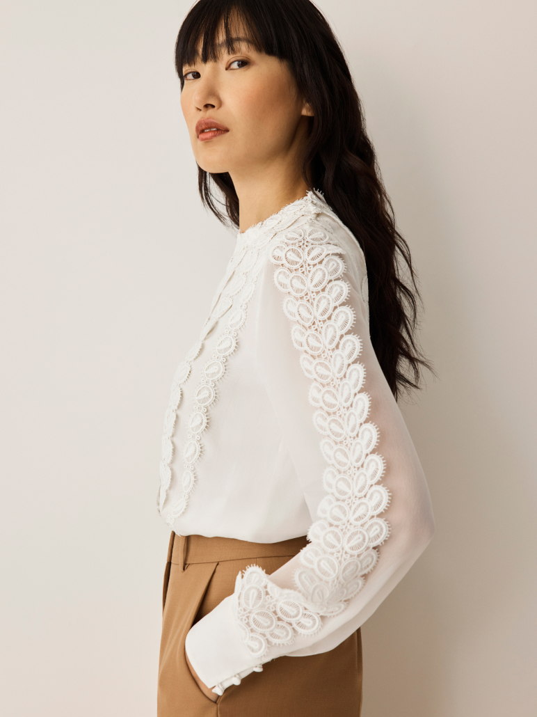 Model wearing Ameria ivory lace blouse