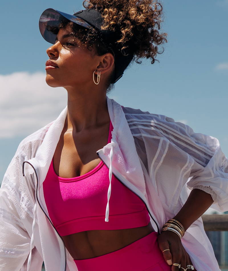 Model wearing various Ring Concierge jewelry in a workout outfit