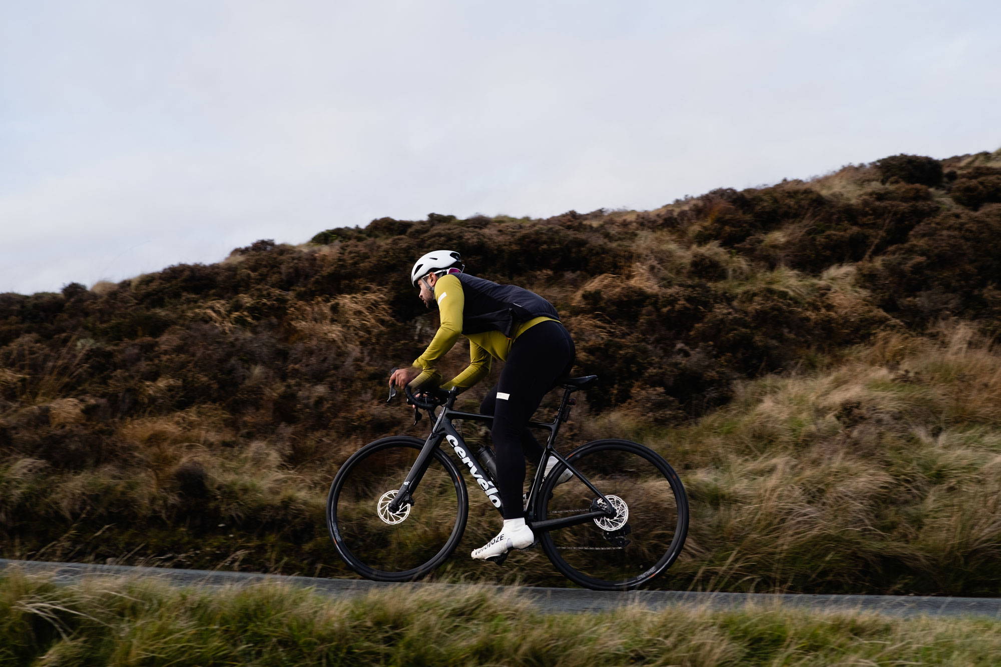 Cyclist climbing hill in Wales