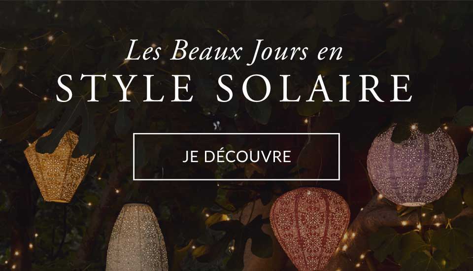 Une séléction de lampions Tyvek suspendue en hauteur dans le jardin. 