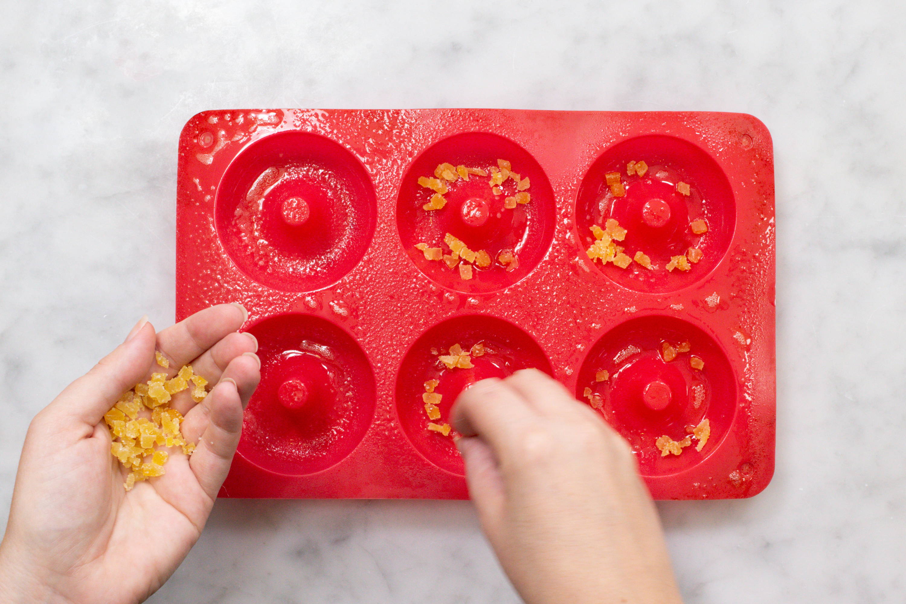 Adding diced ginger to doughnut pan