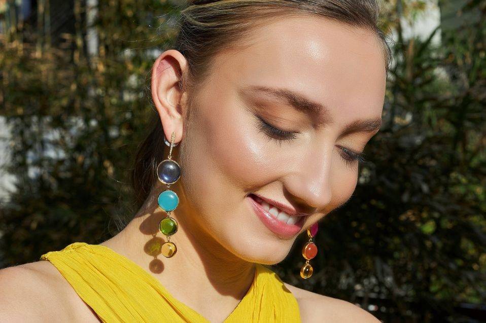 Laura Foote Designs designer statement earring in gold with gemstones on girl in Veronica Beard dress.