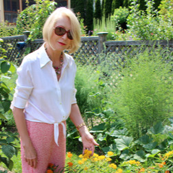 Jane Iredale standing in a garden