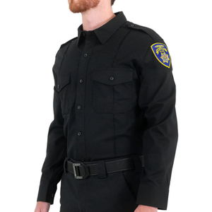 Male police officer in a black uniform, standing sideways.
