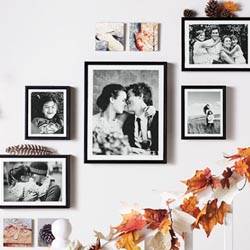 Black and white framed family photos used to make a custom accent wall.