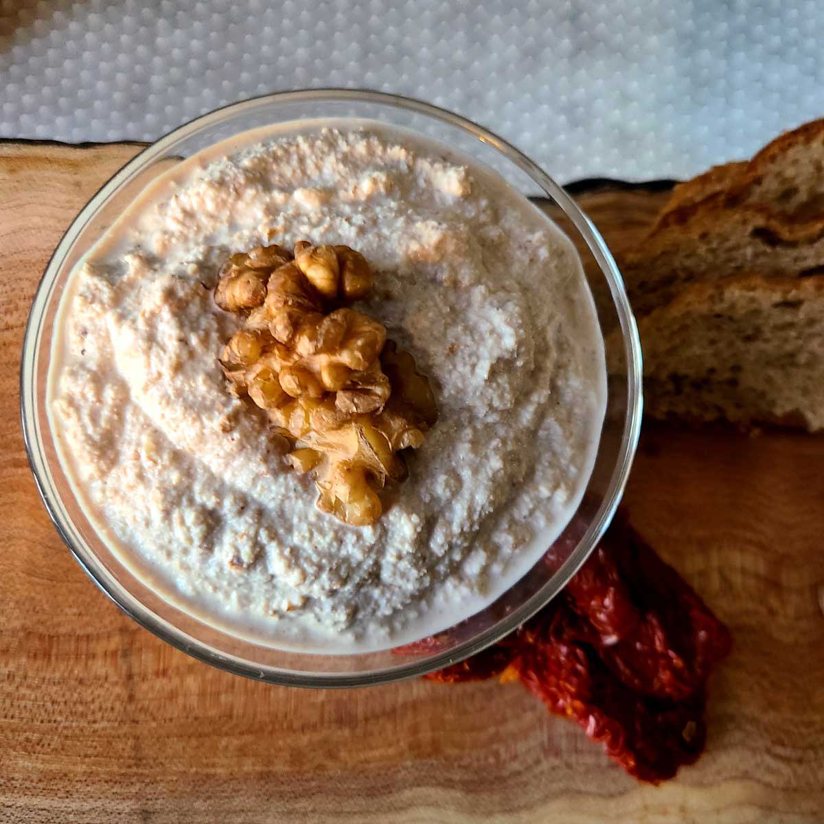 Walnut ricotta in a bown with walnuts on top