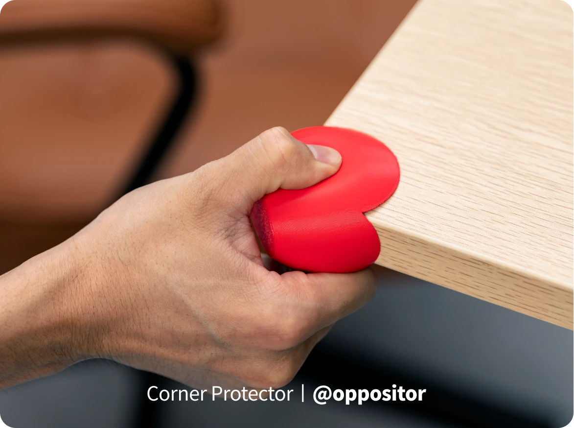 Red TPU 95A HF corner guard pressed by hand to demonstrate flexible shock absorption.