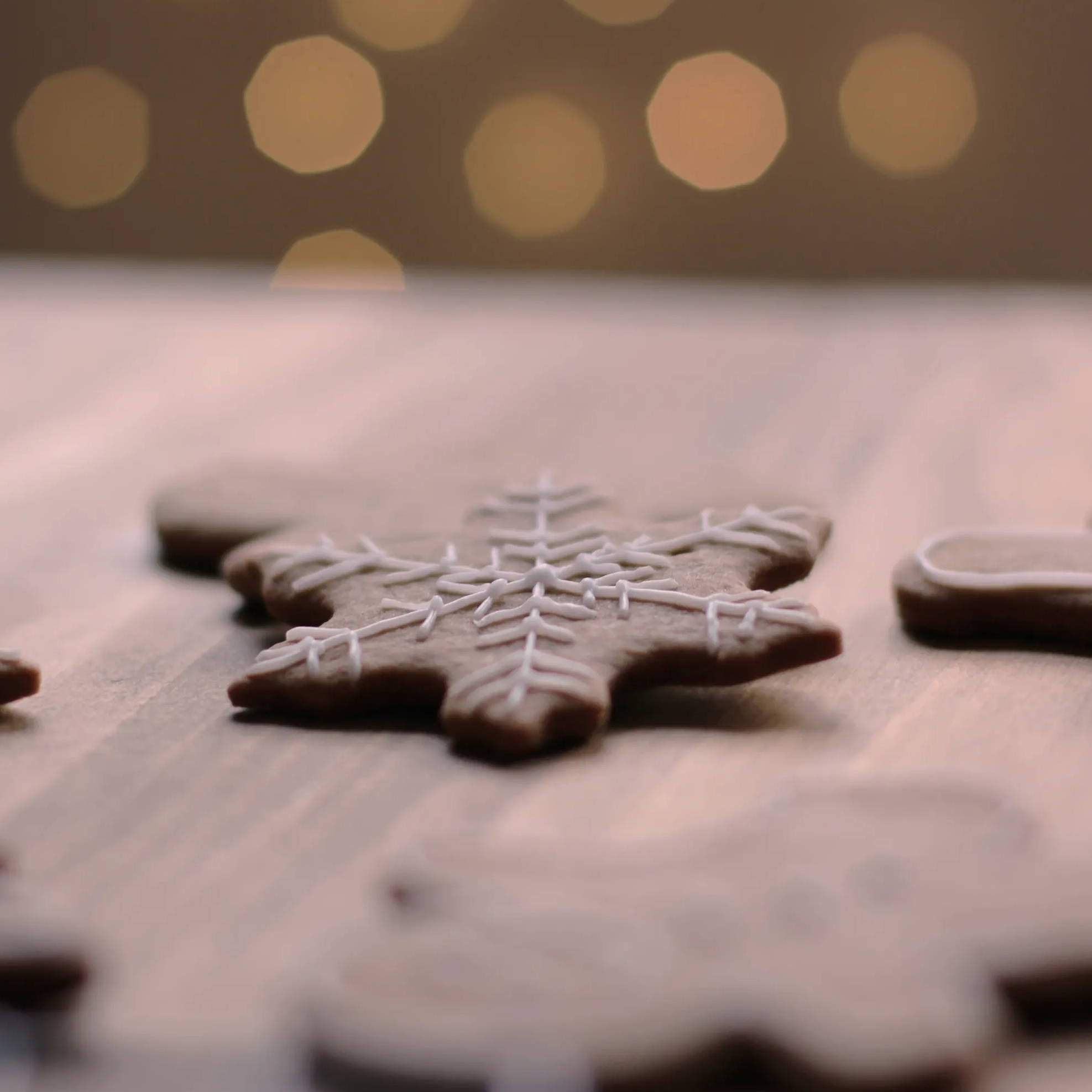 A gingerbread snowflake resting on a kitchen worktop