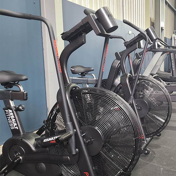 igh School Gym Fit Out featuring air bikes for high-intensity cardio workouts, strategically placed in the fitness zone.