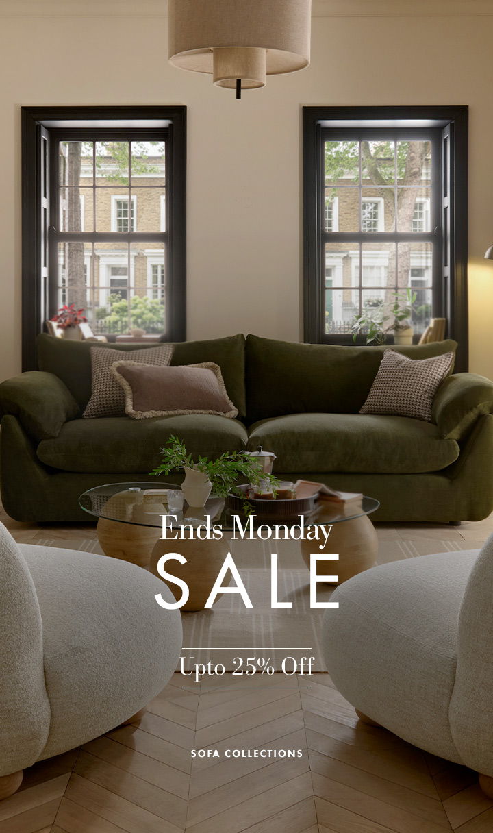 Living room sofas with a sale announcement and discount details.