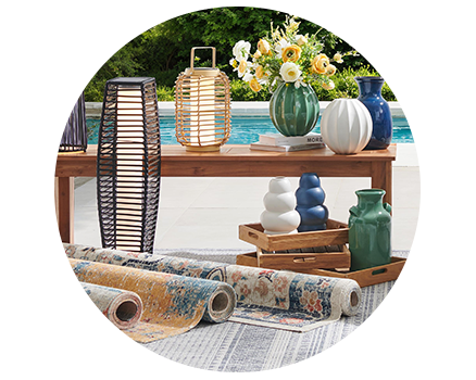 Decorative pillow, green vase, and a lantern on a white background.