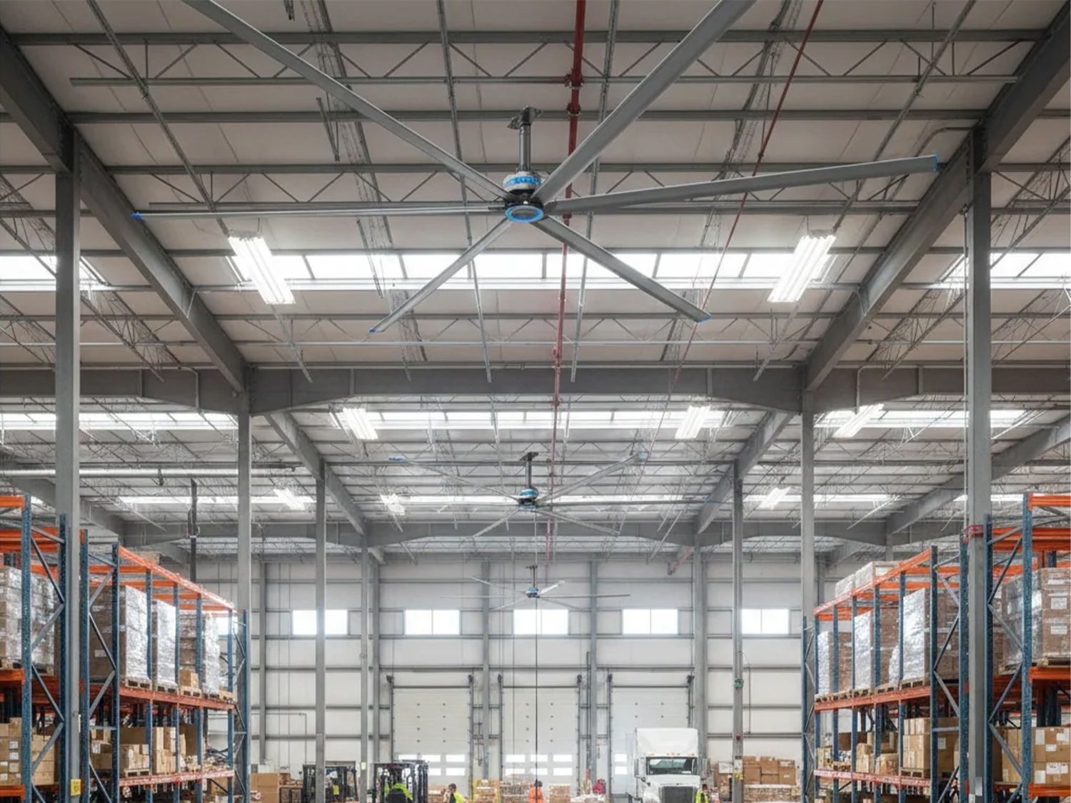 Interior of a warehouse with high ceilings and large ceiling fan.