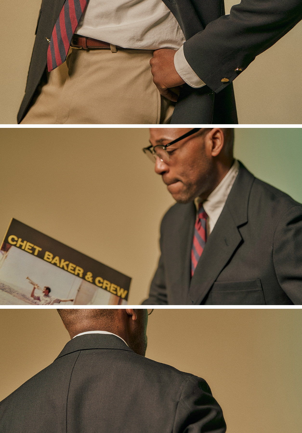 Man in a suit holds a record titled 