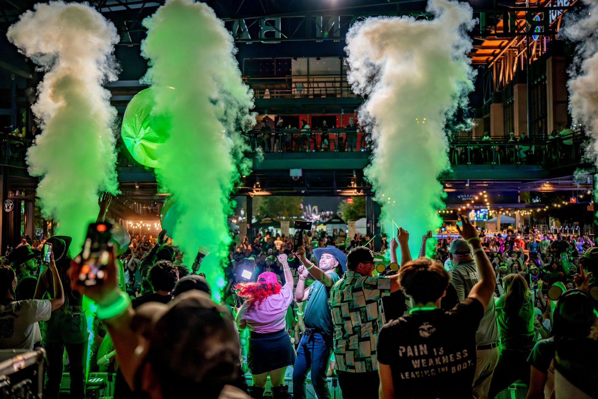 CO2 cannons blast green smoke over the crowd during the Pickle RAVE headlined by national touring DJ PICKLE at The Big Dill pickle festival, Texas Live!, Arlington Texas 2025.