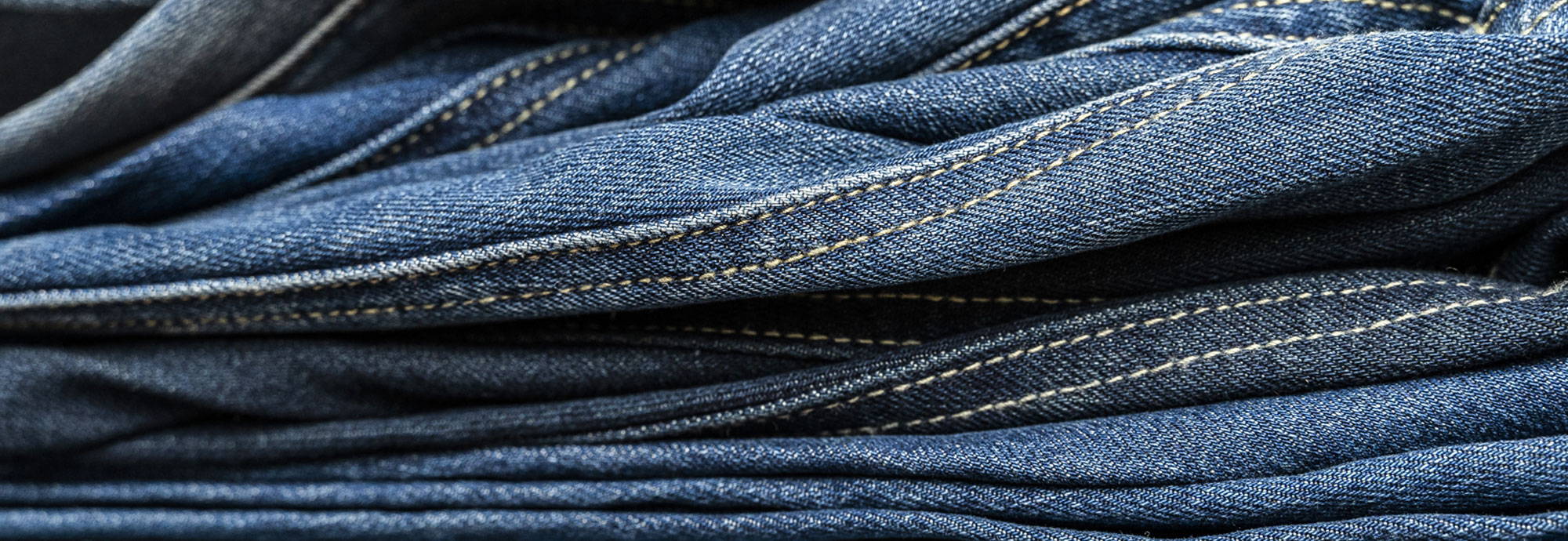 stack-of-tall-blue-jeans