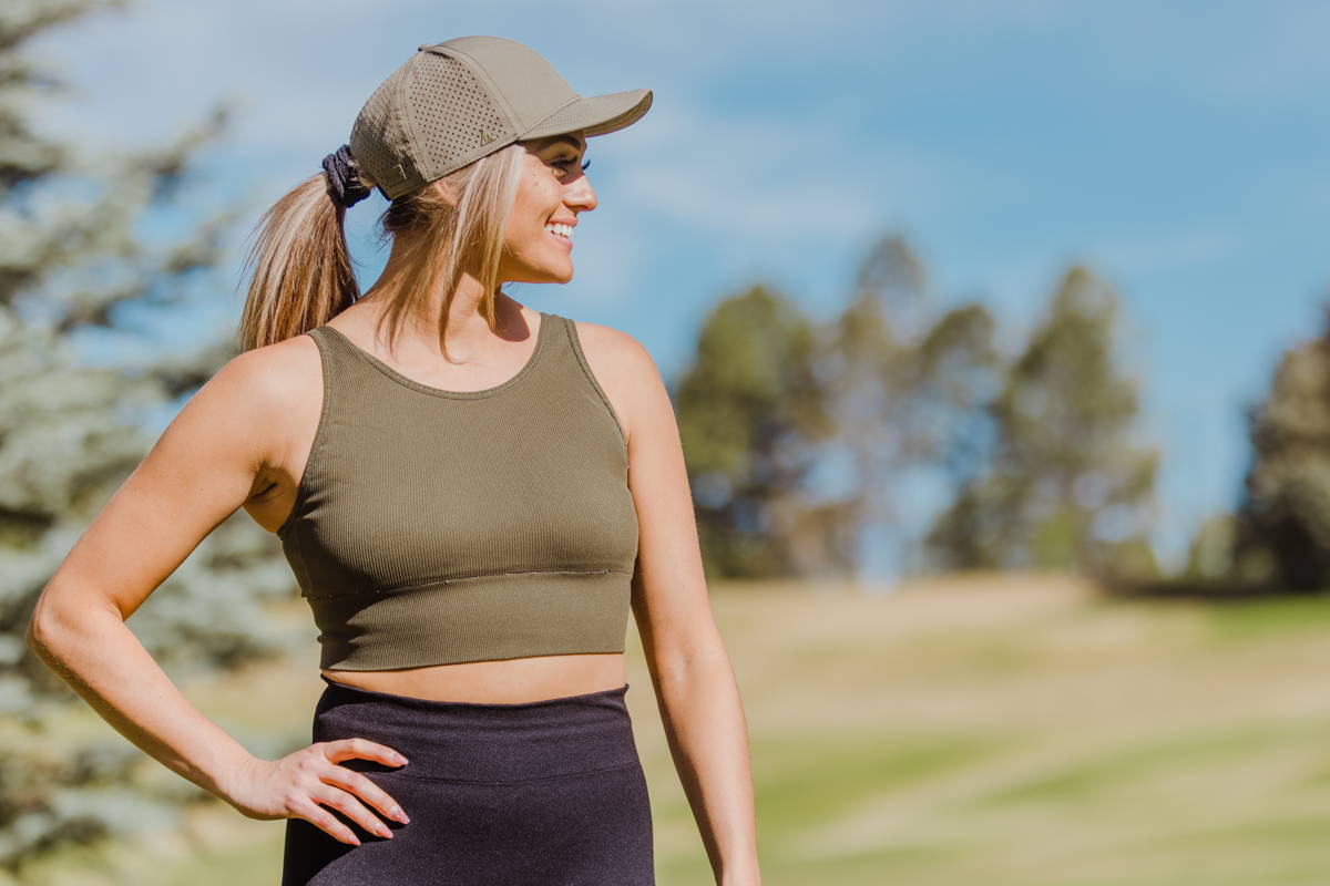 Woman wearing a green running hat