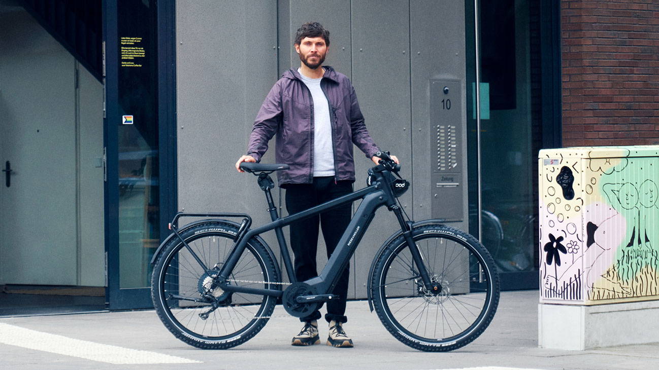 Man stands beside a Riese & Muller Charger4 e-bike