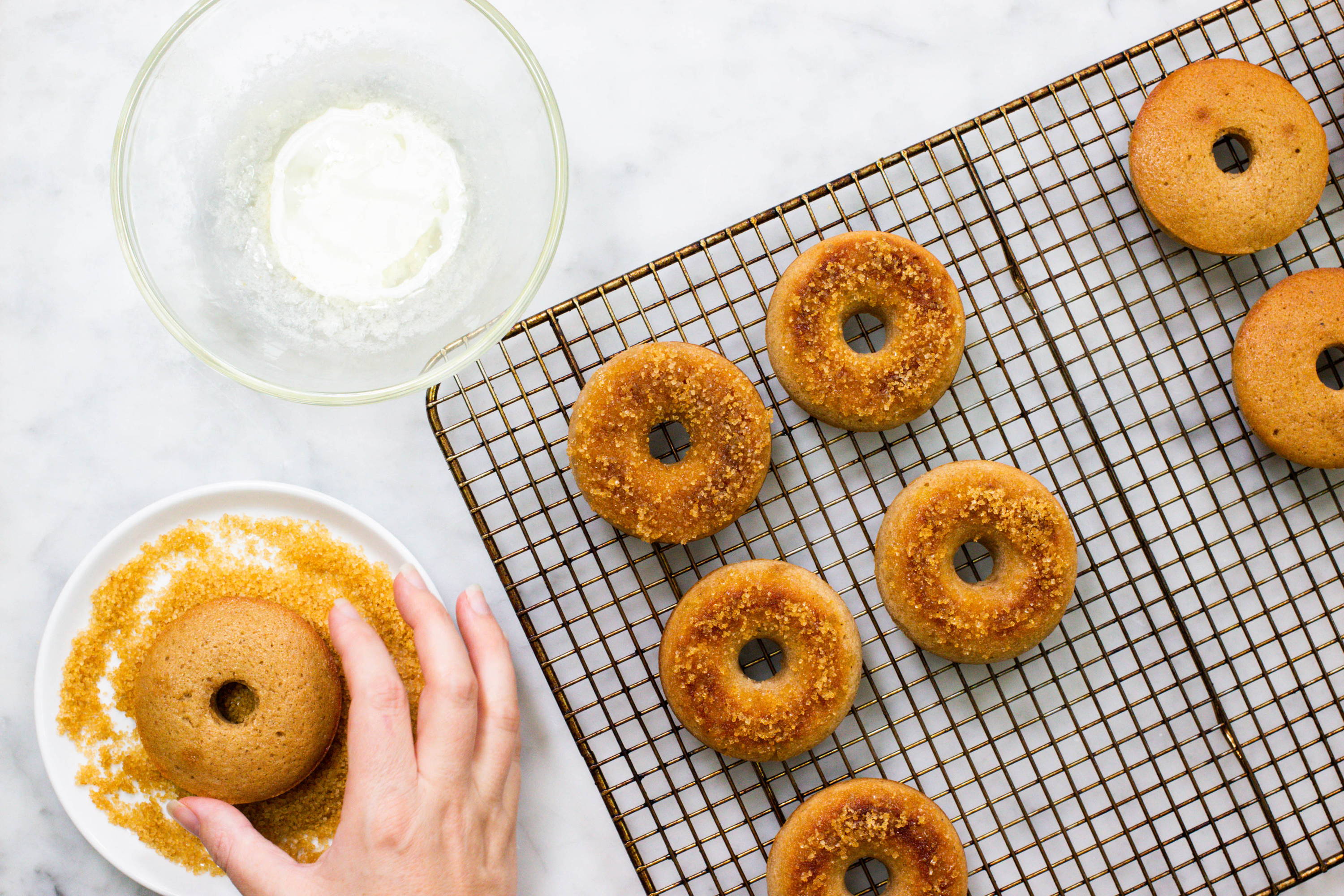 Dipping gingerbread doughnuts in sugar