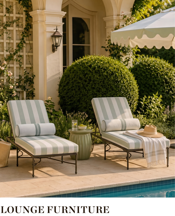 Two lounge chairs by a pool surrounded by greenery and decorative elements.