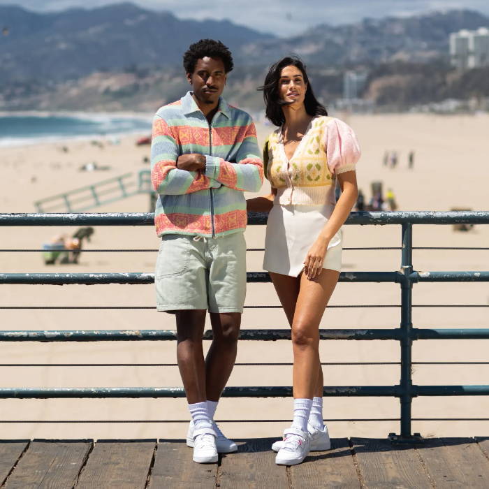 2 models wearing adidas forum standing on pier