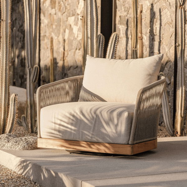 Weather-resistant outdoor swivel chair with performance cushion and woven frame in a low-maintenance desert landscape