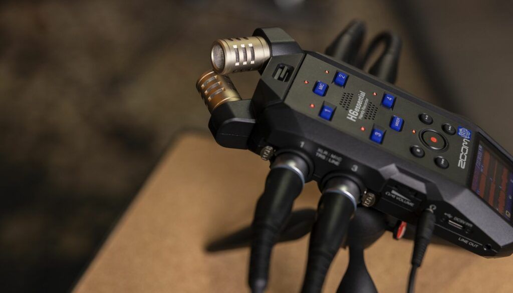 Close-up of a device with buttons and microphone inputs on a table.